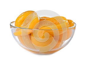 Bowl with halves of canned peaches