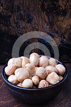 Bowl of hazelnuts on wooden backgrounds