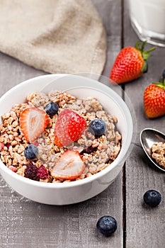 Bowl of healthy cereal granola with strawberries