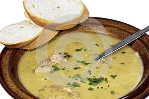 Bowl of Hearty Pea and Ham Soup with Sliced Bread