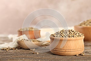 Bowl of hemp seeds on wooden table