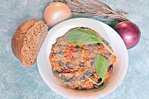 Bowl of homemade chili with onion and spices