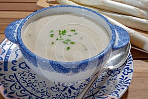 Bowl of homemade cream soup from white asparagus, spring season, new harvest of Dutch, German white asparagus, cooking with