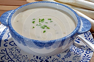 Bowl of homemade cream soup from white asparagus, spring season, new harvest of Dutch, German white asparagus, cooking with