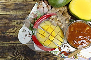 Bowl of homemade Mango Chutney on old wooden table