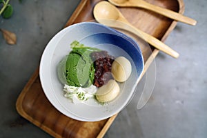 A bowl of homemade matcha ice cream green tea latte served wi