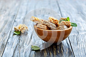 Bowl with honey bars with peanuts, sunflower and sesame seeds.