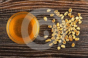 Bowl with honey, scattered puffed wheat on table. Top view