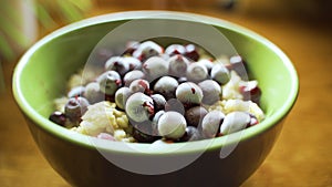 A bowl of hot oatmeal with fresh frozen currants