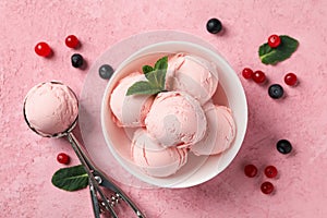 Bowl with ice cream and berries on background, top view