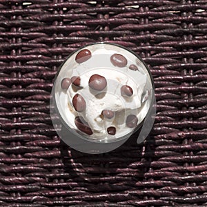 Bowl of ice cream with chocolate raisins, top view