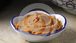 Bowl with Japanese shinshu shiro miso paste close up