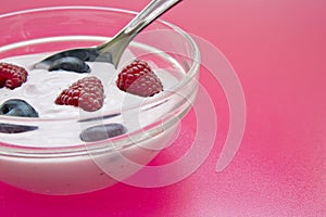 Bowl with jogurt and spoon on background