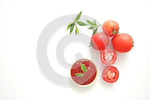 Bowl of ketchup or tomatoes sauce with ingredients on white background