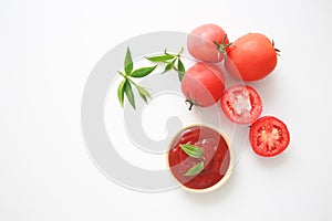 Bowl of ketchup or tomatoes sauce with ingredients on white background