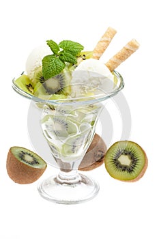 A bowl of kiwi ice cream with kiwis and cones isolated on white background with waffles