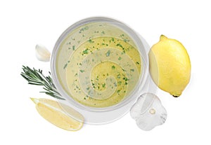 Bowl with lemon sauce and ingredients on white background, top view. Delicious salad dressing