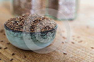 Bowl with linseed grain on wooden table