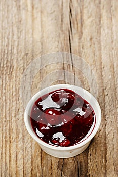 Bowl of marmalade on wooden table