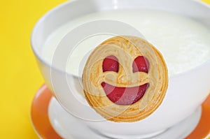Bowl with milk and cookie