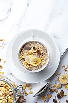 Bowl of milk with whole grains for breakfast. Muesli with dried fruits and dried fruits. With copy space. On light background