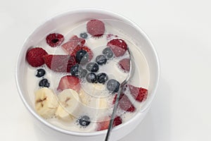 Bowl with Mixed Fruit Berry Variety and Almond Milk over Cereal
