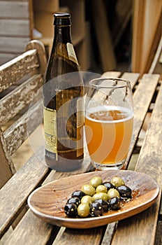 Bowl of mixed olives and glass of beer