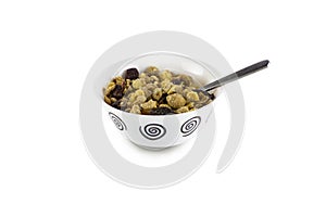 Bowl of muesli with dry fruits and spoon on white background