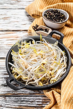 Bowl with Mungbean Sprouts on wooden background. White background. Top view photo