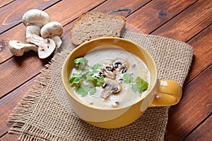 A bowl of Mushroom Cream Soup with fried champignons and fresh parsley