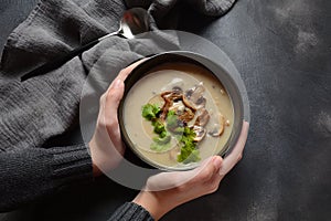 A bowl of Mushroom Cream Soup with fried champignons and fresh parsley