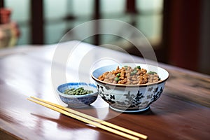 bowl of natto with chopsticks on wooden table