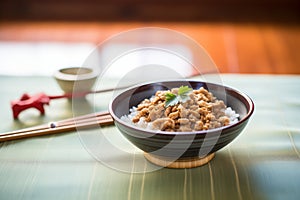 a bowl of natto fermented soybeans on a table