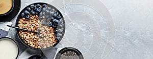 Bowl of oat with blueberries served on light marble table, flat lay with space for text. Banner design