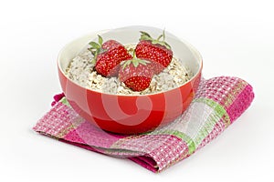 Bowl with oatmeal and fresh strawberries