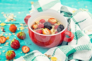 Bowl of oatmeal porridge with fresh berries: blackberry, strawberry and raspberry on . Healthy food for breakfast