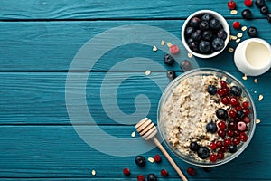 Bowl with oatmeal porridge and fruits on wooden background Cooking breakfast