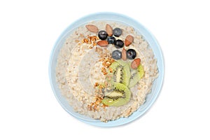 Bowl with oatmeal porridge and ingredients isolated on background