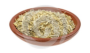 Bowl of oatstraw herb on a white background photo