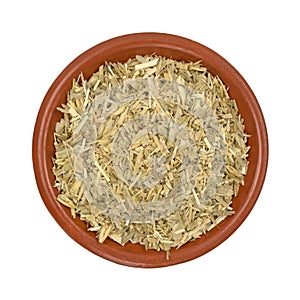 Bowl of oatstraw herb on a white background photo