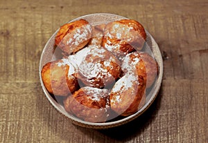 Bowl with oliebollen for new years eve - bowl with deep fried doughnut balls, a dutch tradition