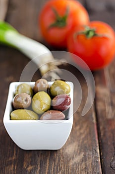 Bowl with olives, tomatoes and green onion