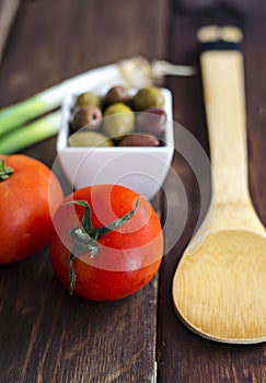 Bowl with olives, tomatoes and green onion