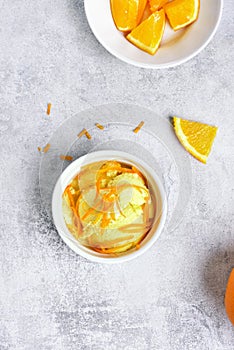 Bowl with orange ice cream, top view