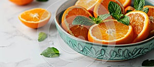 Bowl of Oranges With Mint Leaves