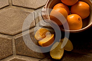 Bowl of oranges on Spanish tile floor