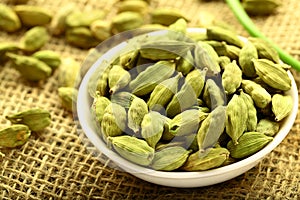 Bowl of organic cardamom pods.