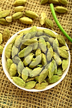 Bowl of organic cardamom pods.