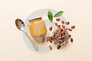 Bowl of peanut butter and peanuts on table background. top view with copy space. Creamy peanut pasta in small bowl