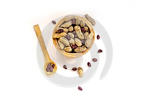 Bowl with peanuts in shell on white background